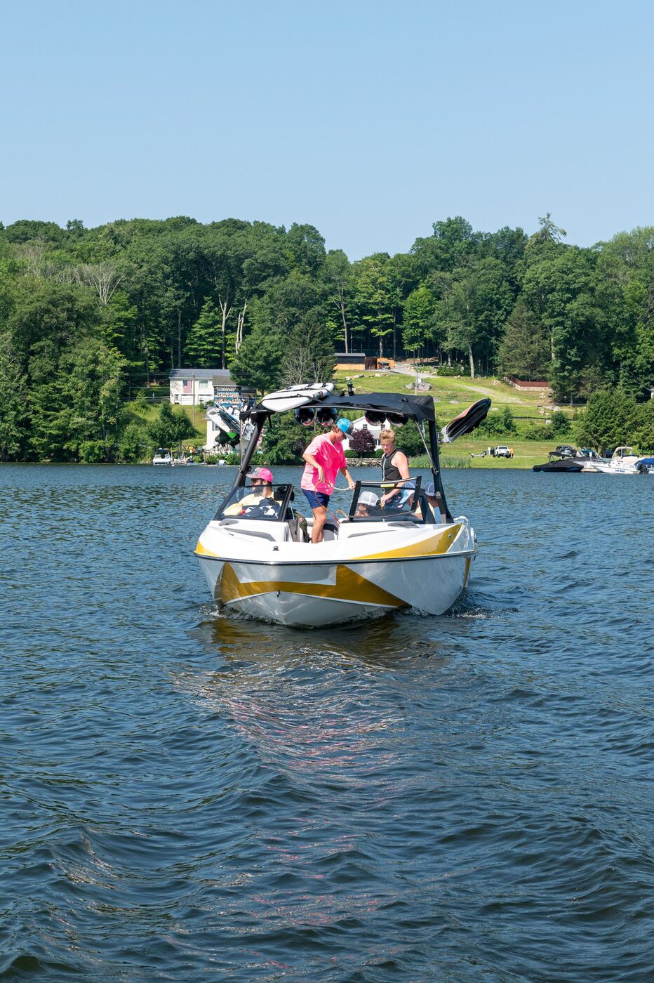 Family relaxing on a boat on a Connecticut lake